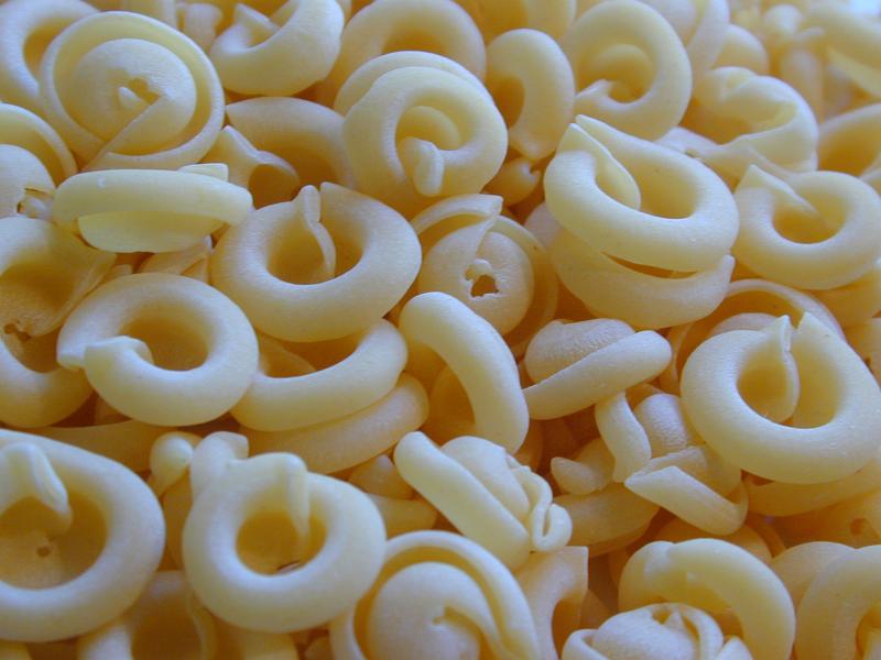 Free Stock Photo: Background of circular dried uncooked Italian pasta made from durum wheat dough for traditional mediterranean cuisine
