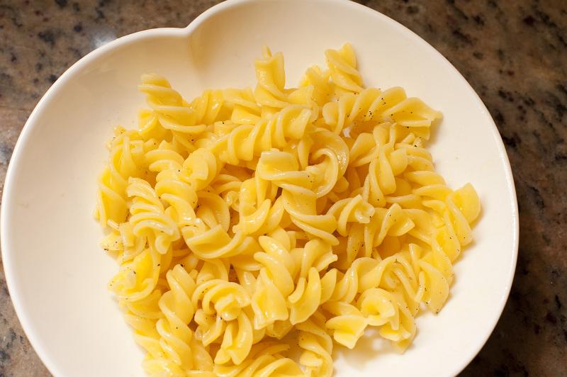 Free Stock Photo: Plate of cooked spiral Italian pasta ready for the addition of a tasty savory sauce and parmesan cheese