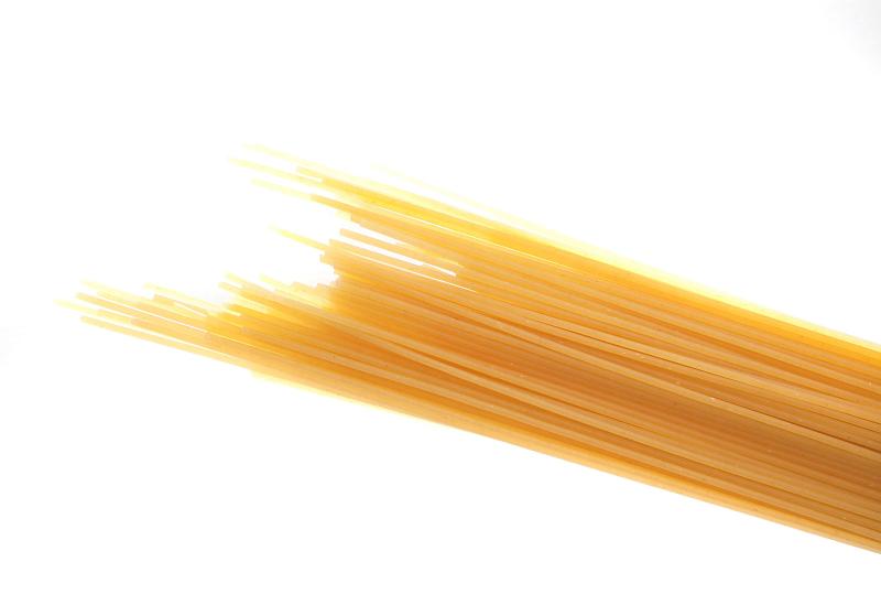 Free Stock Photo: Bundle of uncooked dried Italian spaghetti pasta made from durum wheat dough as an ingredient in Mediterranean cuisine isolated on white