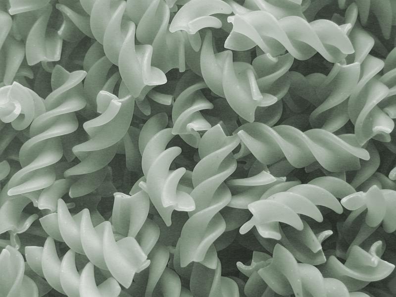 Free Stock Photo: Monochrome fusilli pasta background texture with the traditional spiral twisted Italian noodles in a random jumble