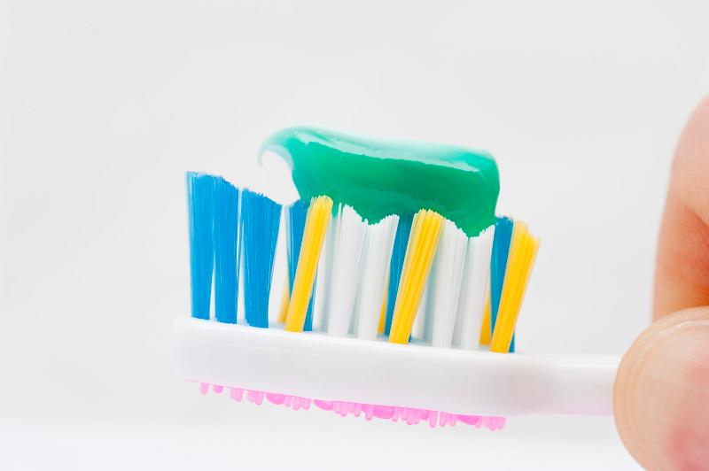 Free Stock Photo: close up on a toothbrush with green toothpaste on it
