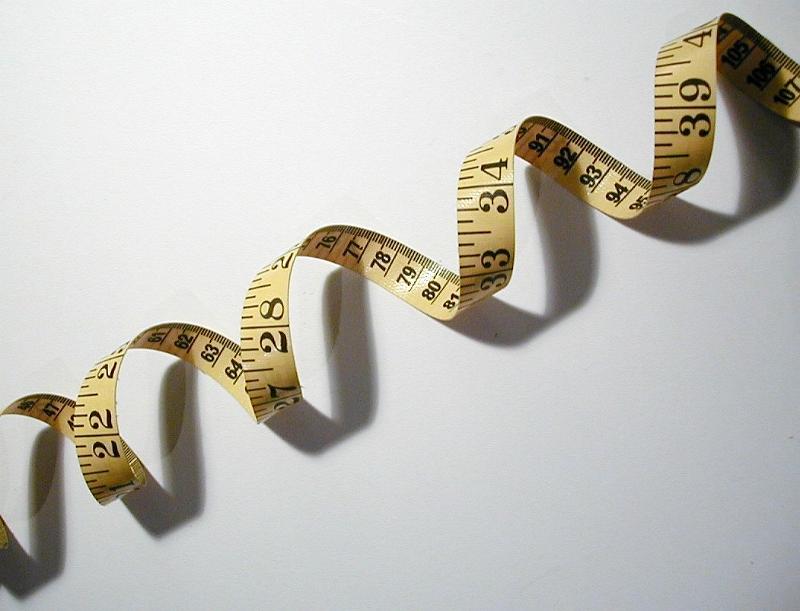Free Stock Photo: an metric and imperial measuring tape coiled up