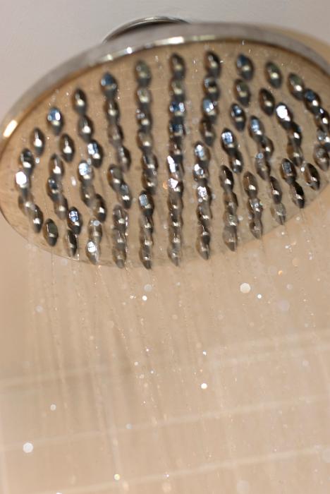 Free Stock Photo: water droplets running from a large shower head