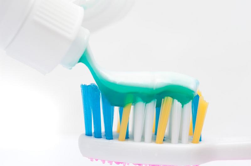 Free Stock Photo: dispensing toothpaste onto a tooth brush