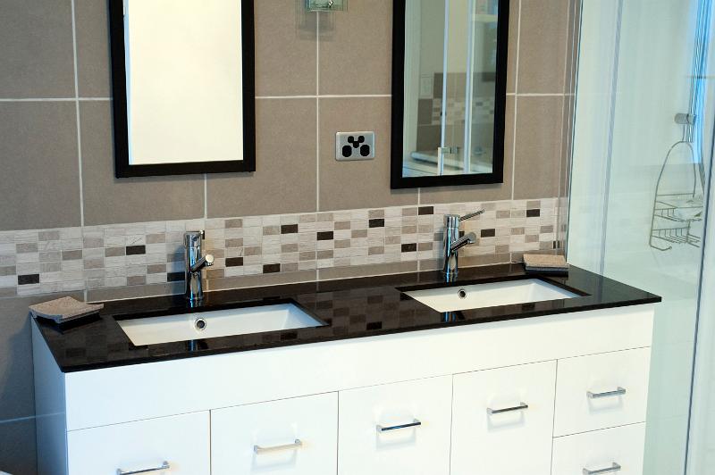 Free Stock Photo: a modern bathroom with dual sinks in a stone topped sink unit