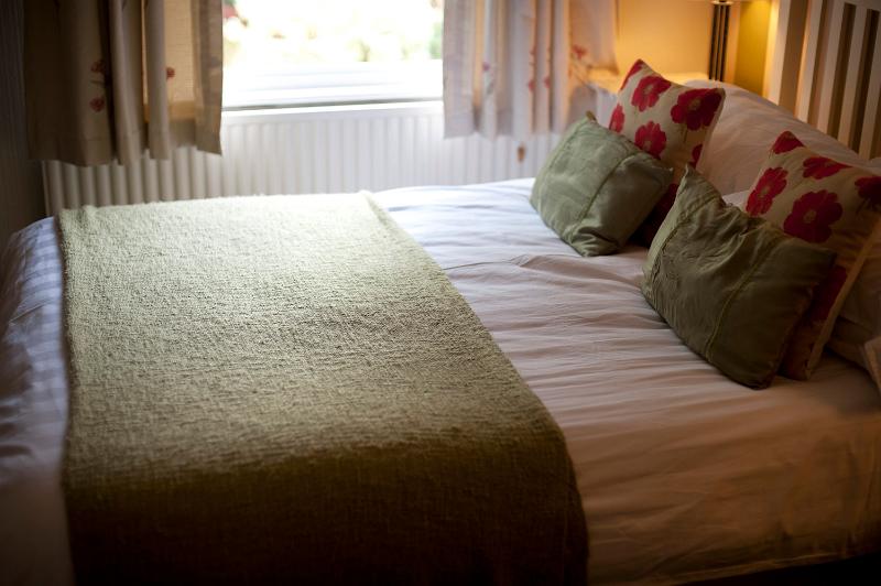 Free Stock Photo: Comfortable relaxing double bed with neutral decor in daylight from a window
