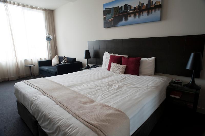 Free Stock Photo: Hotel bedroom suite with modern decor and a double bed alongside a large window
