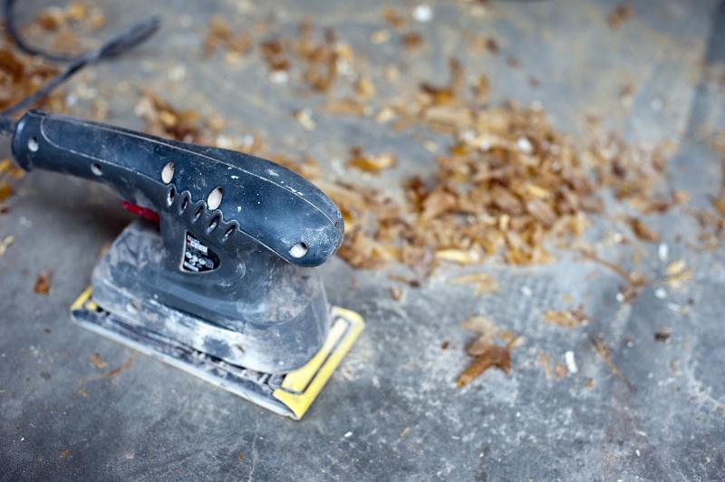Free Stock Photo: High angle view of an electric sander in a woodworking workshop with wood shavings and copyspace