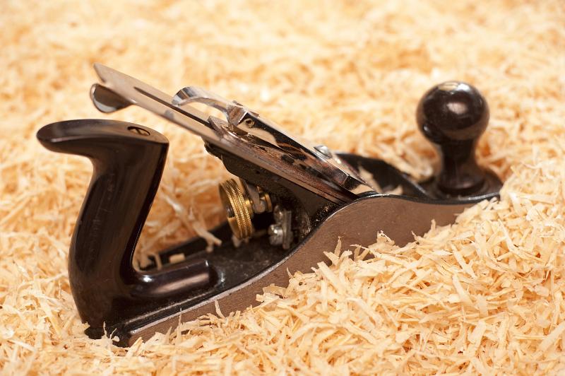 Free Stock Photo: Wood plane on a pile of sawdust and wood chips with copyspace in a DIY and woodworking concept