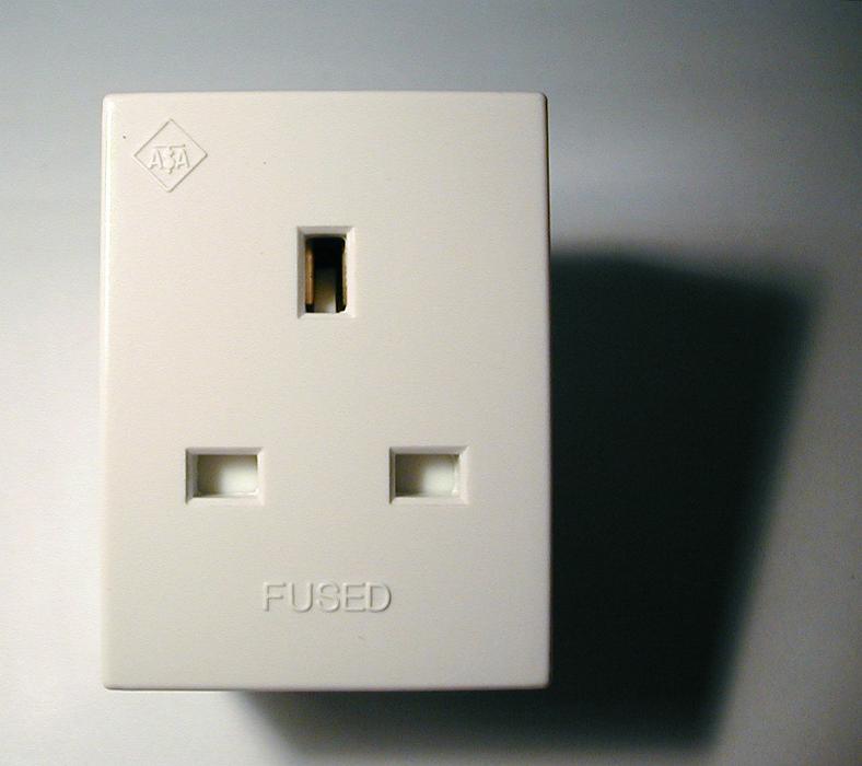 Free Stock Photo: White plastic British grounded adaptor or electrical socket for a plug