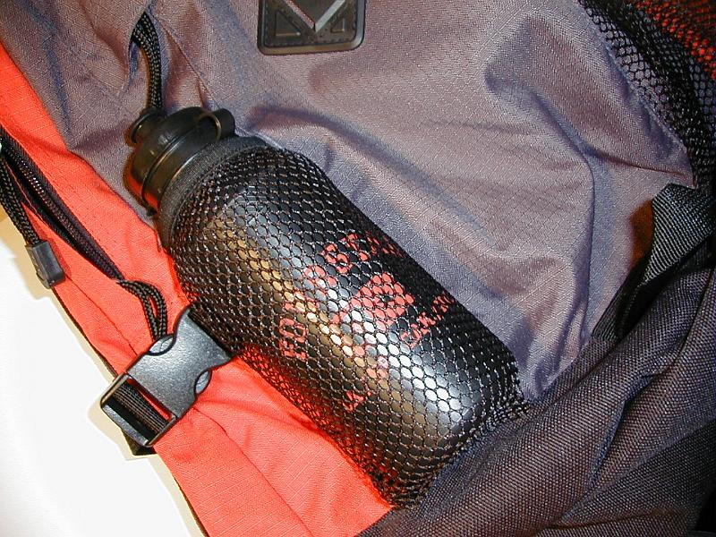 Free Stock Photo: Open backpack with a plastic bottle for water or liquid refreshment lying in the compartment conceptual of a healthy outdoor lifestyle