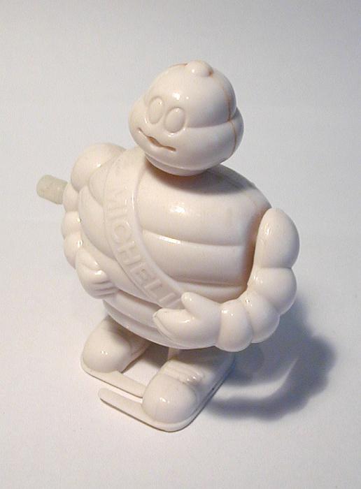 Free Stock Photo: Still Life of Michelin Man Mascot Wind Up Toy on White Background