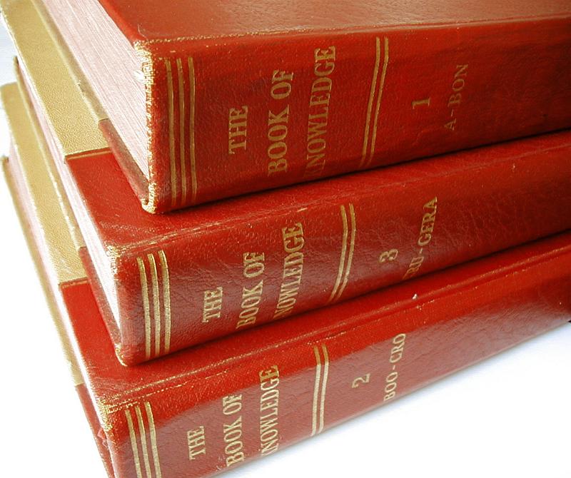 Free Stock Photo: Close Up of Three Old Numbered Encyclopedia Book Volumes with Red Leather Spines Stacked on White Background