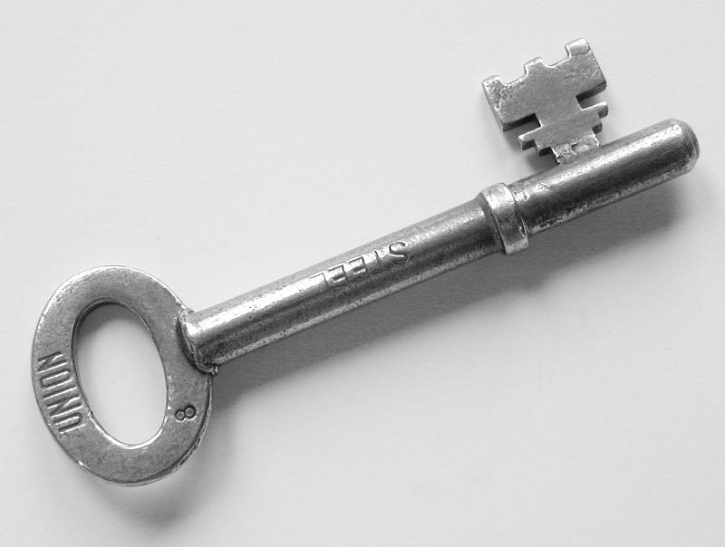 Free Stock Photo: Steel house key stamped - Union - lying diagonally across the frame on white with copyspace