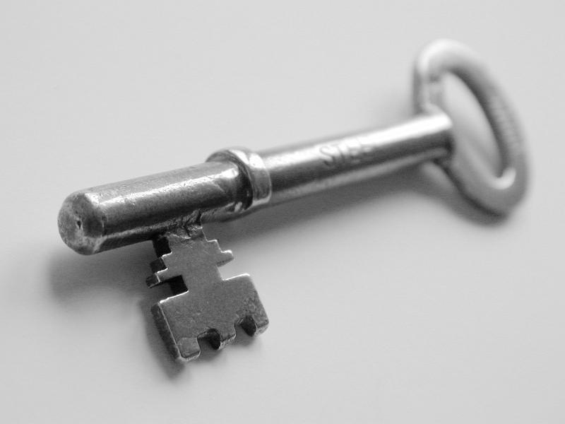 Free Stock Photo: Selective Focus Close Up of Silver Metallic Skeleton Key on White Background