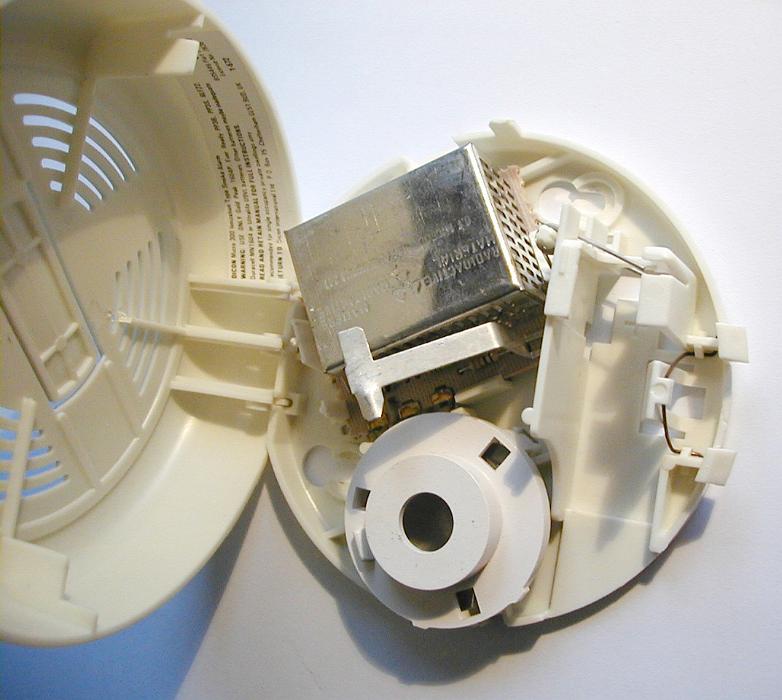 Free Stock Photo: Smoke Detector with Open Casing Showing Different Components Affixed to White Ceiling