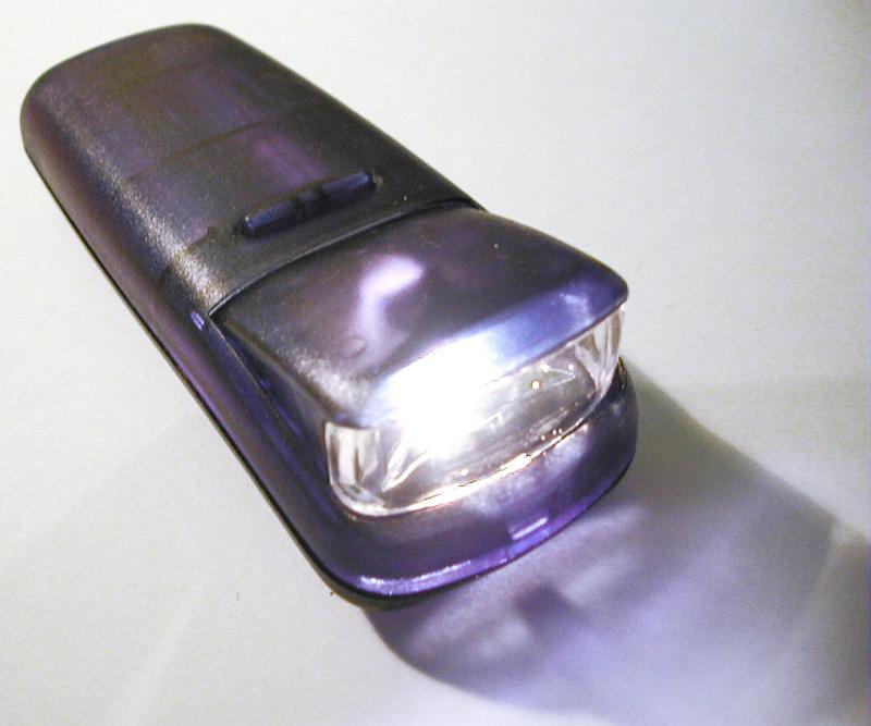 Free Stock Photo: Close Up of Illuminated Purple Flashlight Torch with Lit Lamp on White Background