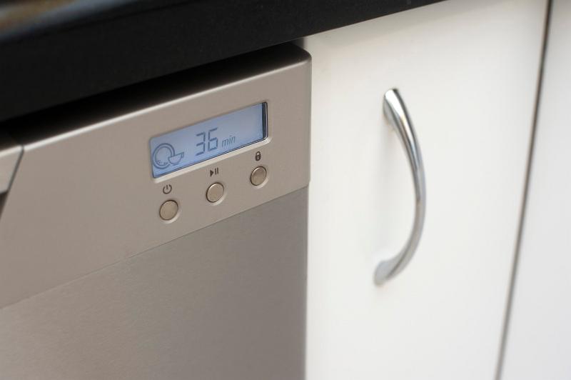 Free Stock Photo: Programmable digital display on the front of a modern metallic dishwasher in the kitchen for washing dirty crockery and glassware