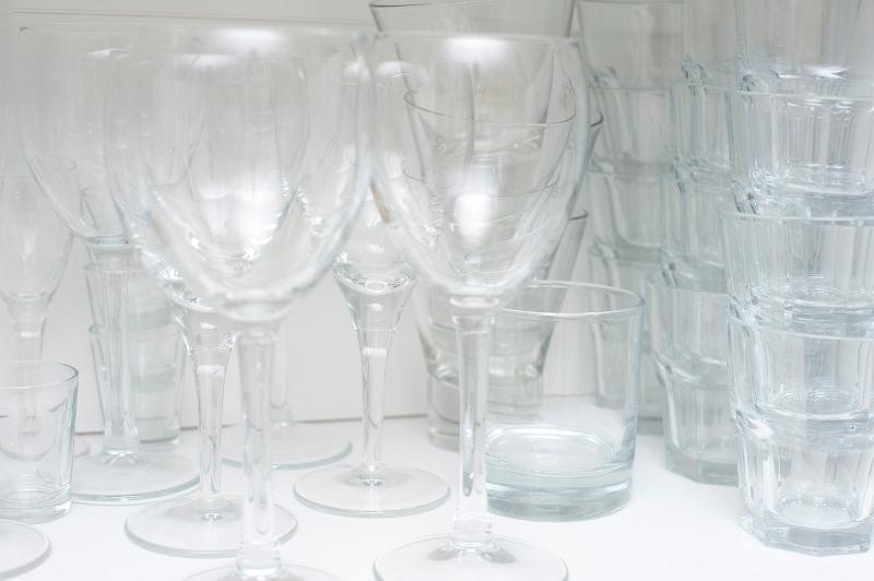 Free Stock Photo: Wine and water glasses on a shelf in a white cupboard