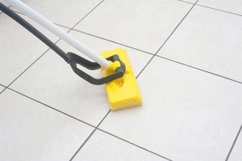 Free Stock Photo: Kitchen mop being used to clean a modern white tiled kitchen floor