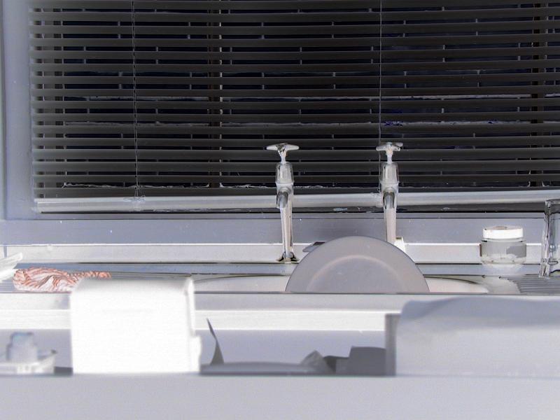 Free Stock Photo: View acrosss kitchen countertops to a kitchen sink with dishes in it