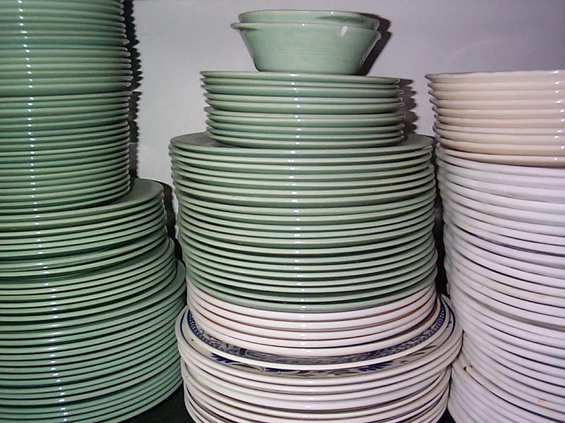 Free Stock Photo: Stacked dinner plates of different size on a shelf