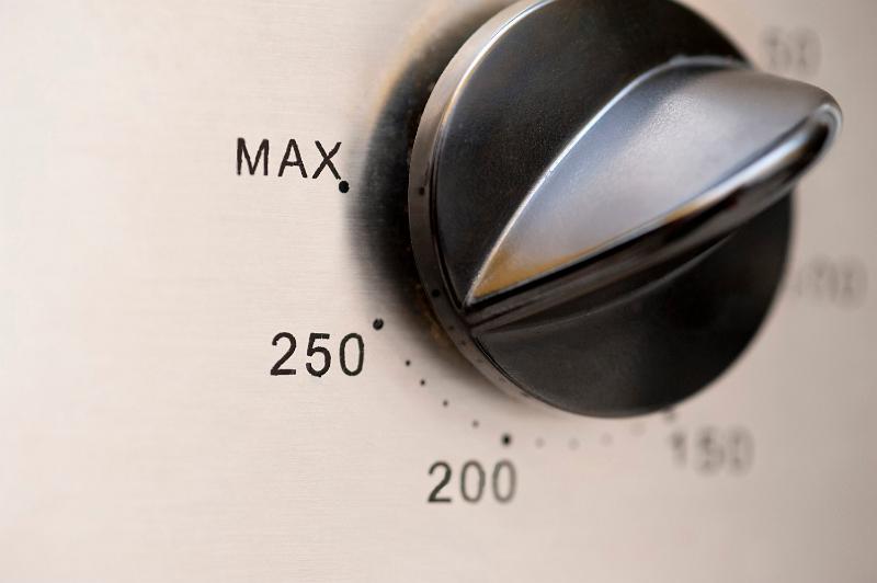 Free Stock Photo: Closeup of a circular oven thermostat control knob with various temperature settings for cooking