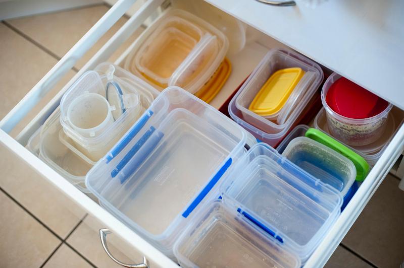 Free Stock Photo: Open drawer in a kitchen unit used for storage and filled with neatly arranged plastic storage containers for food