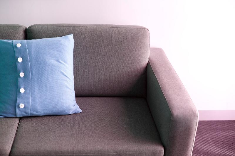 Free Stock Photo: Blue cushion with button decoration on a comfortable settee, close up view