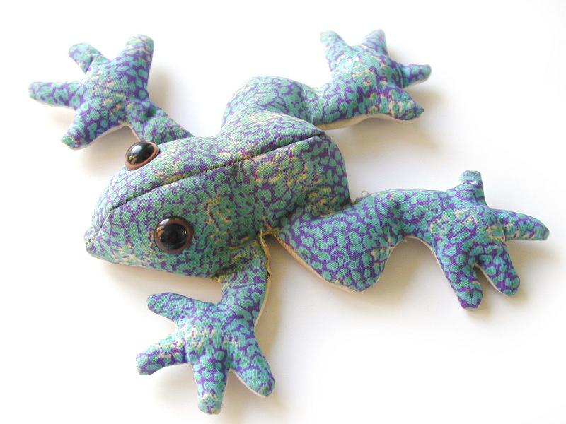 Free Stock Photo: Soft toy frog made of mottled blue fabric lying splayed out on a white background