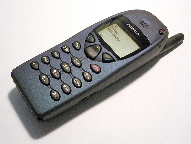 Free Stock Photo: Old retro Nokia mobile phone with a cast shadow on a white background lying diagonally across the frame