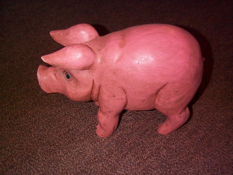 Free Stock Photo: Naturalistic carved cute pink wooden pig ornament, high angle view standing sideways to the camera with its ears cocked forwards