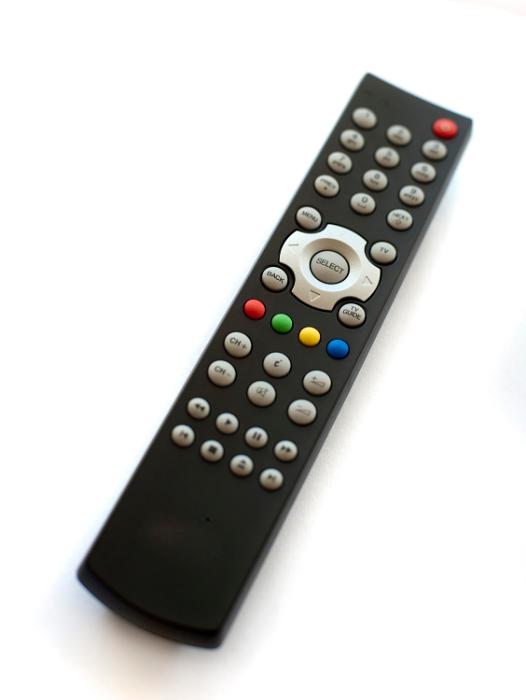 Free Stock Photo: Infrared or wireless remote control for a television lying at an oblique angle on a white background