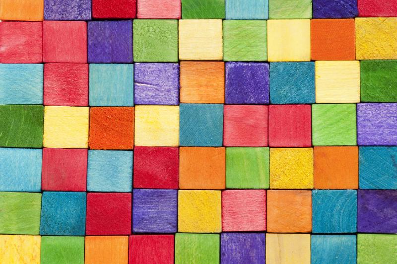 Free Stock Photo: Background pattern of colorful toy wooden blocks or cubes in the colors of the rainbow neatly arranged in rows
