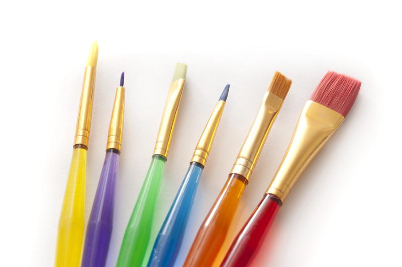 Free Stock Photo: Selection of colorful paint brushes for kids with translucent plastic handles and assorted tips on a white background