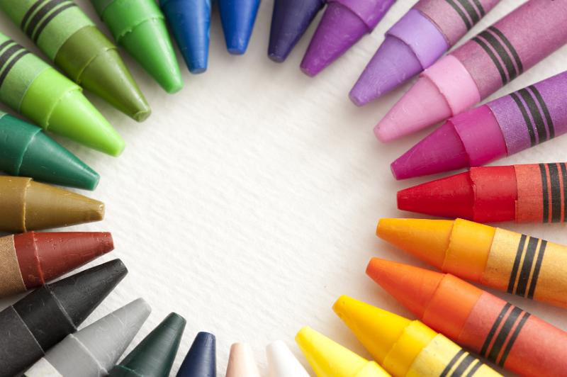Free Stock Photo: Frame of colorful wax crayons with their points facing inwards in a radiating circle with central blank white copy space