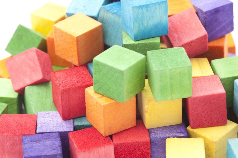Free Stock Photo: Abstract Background - Close Up of Colorful Wooden Blocks Piled in Studio with White Background - Childhood Toy Concept Image
