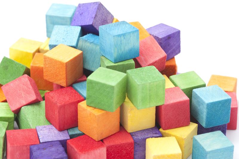 Free Stock Photo: Jumbled Pile of Multi-Colored Wooden Cube Blocks Stacked in Studio with White Background and Copy Space - Childhood Concept Image