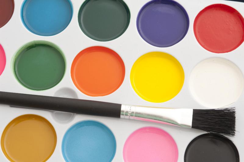 Free Stock Photo: New water color paints in an open box with an unused paint brush in a close up overhead view