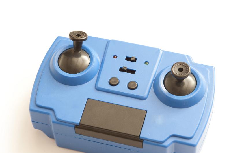 Free Stock Photo: Close up of generic blue electronic toy controller made from two joysticks, buttons and slide switches with copy space over white background