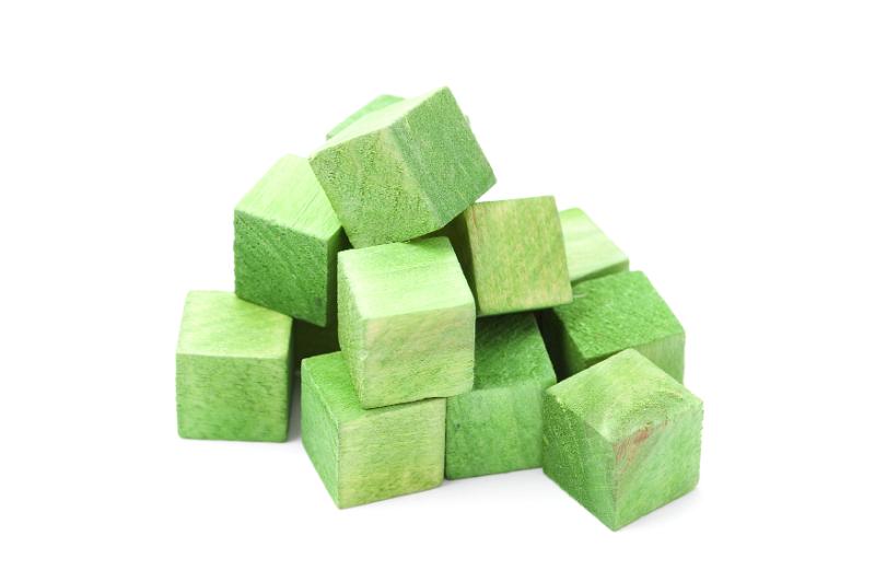Free Stock Photo: Pile of educational green wooden cubes or building blocks for young children to play with over a white background