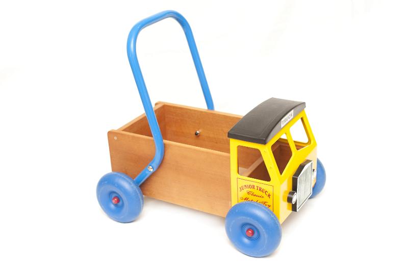 Free Stock Photo: Colorful kids toy walker truck with a metal handle to push it along isolated on a white background