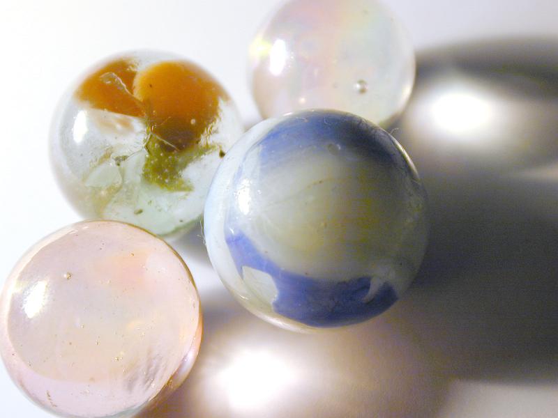 Free Stock Photo: An assortement of childrens traditional toy glass and stone marbles