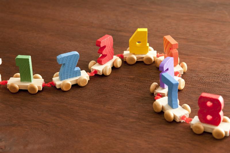 Free Stock Photo: A wooden toy train with numbers on each carriage