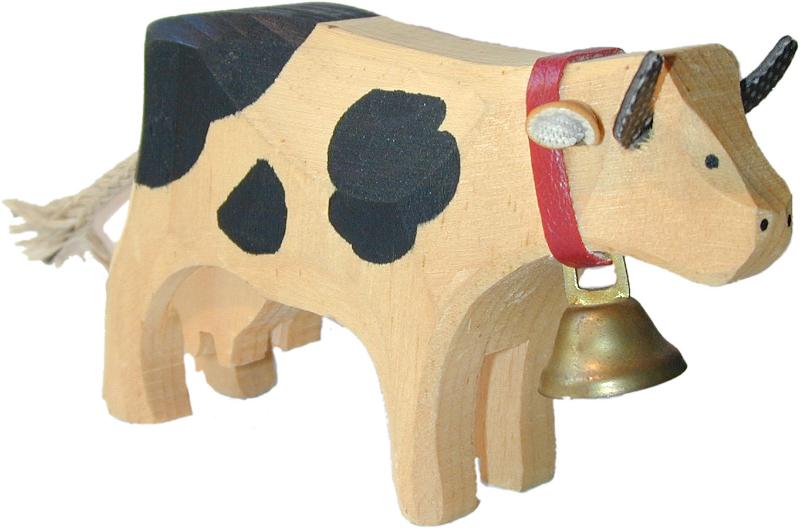Free Stock Photo: Rustic hand carved wooden cow with a bell around its neck and black markings isolated on white