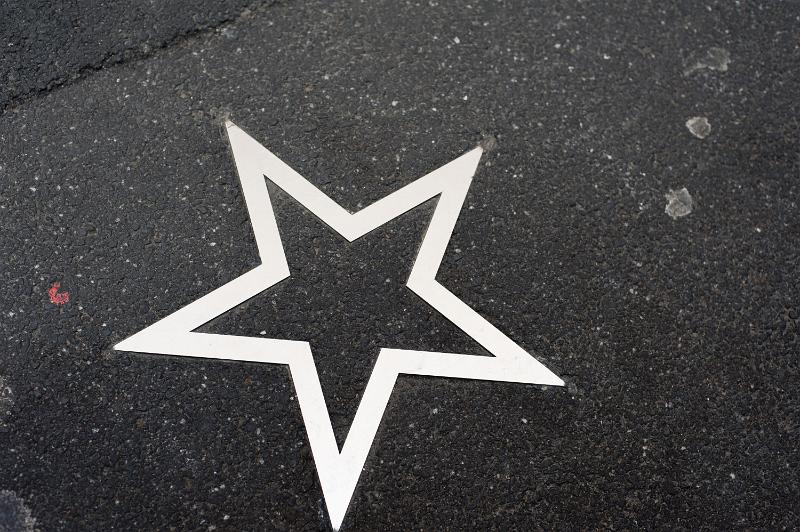 Free Stock Photo: White five pointed star painted on a road or sidewalk conceptual of the walk of fame to honour celebrities