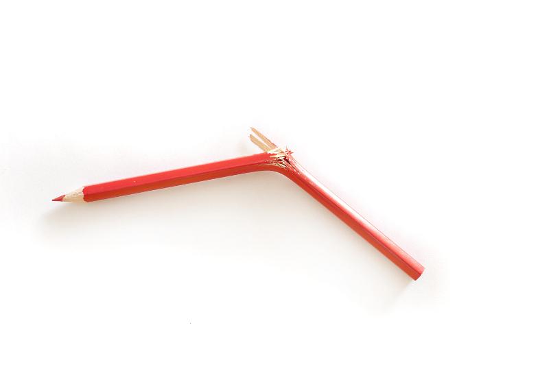 Free Stock Photo: Broken red pencil crayon snapped in half in a fit of frustration on a white background with copy space