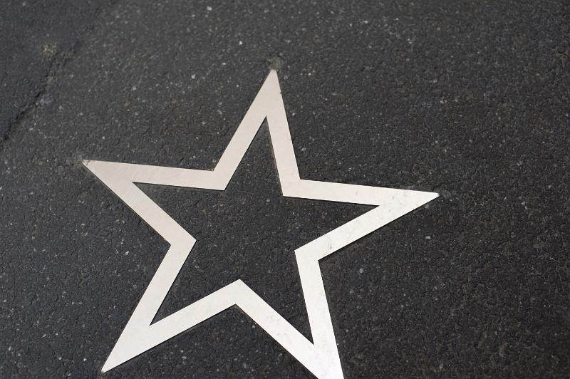 Free Stock Photo: White five pointed star paved on the asphalt walkway, viewed in close-up from above