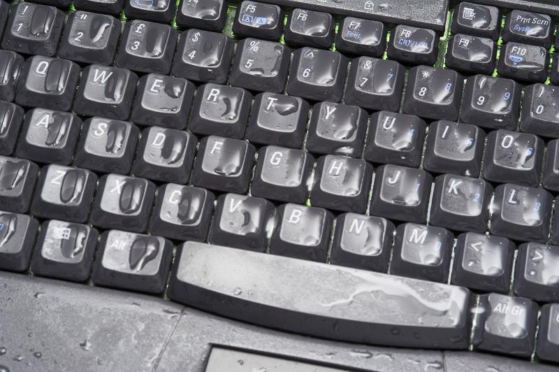 Free Stock Photo: Wet personal computer black keyboard damaged by water, viewed in close-up full frame