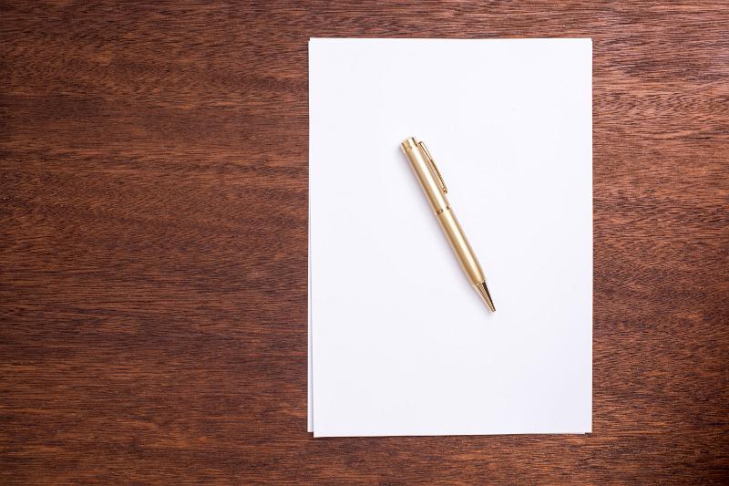 Free Stock Photo: Concept of writers block with blank white page of paper with a ballpoint pen on top lying on a desk viewed from above